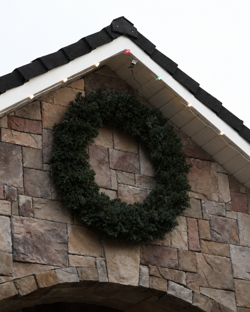 Green wreath on a stone house facade